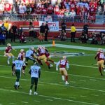 A football game is being played in a stadium